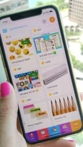 Image of a woman holding a cell phone showing free school supplies on the ClassTag Parent-Teacher app.