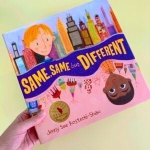 Cover of book called Same, Same but Different, showing two diverse children from different cultures with different city-scapes behind them.