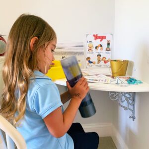 Child playing with bottle while cooling off in the calm down corner. 