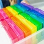 Image showing colored photo boxes in a larger plastic box. The boxes are the perfect size to keep reading task cards.