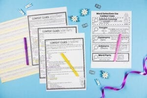 Context Clues Activities and anchor chart with colored pencils and a purple ribbon