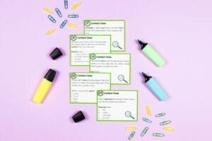 Teaching Context Clues task cards with highlighters and paper clips on a purple background