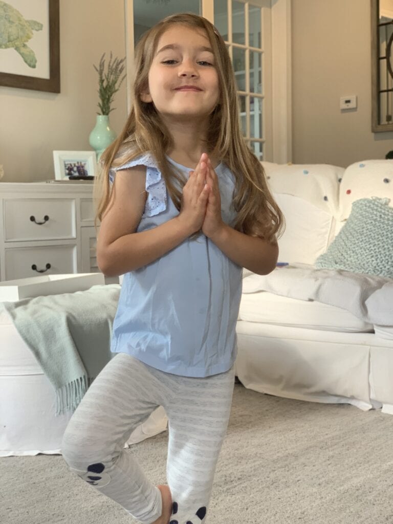 Girl doing a yoga pose to take a brain break from distance learning