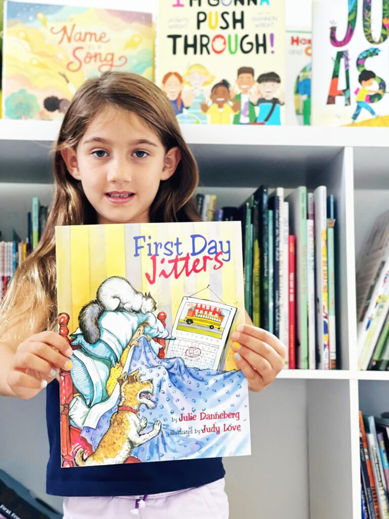 Student holding back to school book First Day Jitters