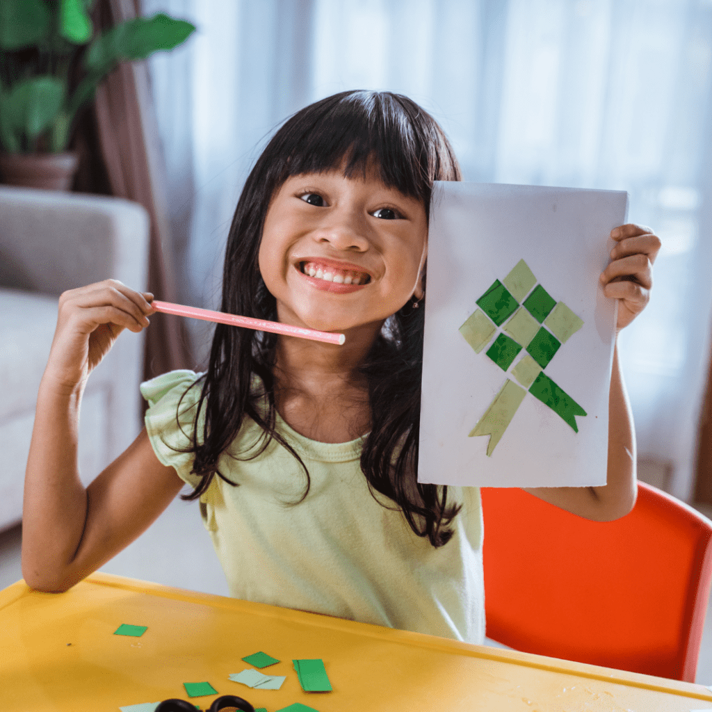 Girl showing Christmas bow drawing created during a winter holiday classroom party