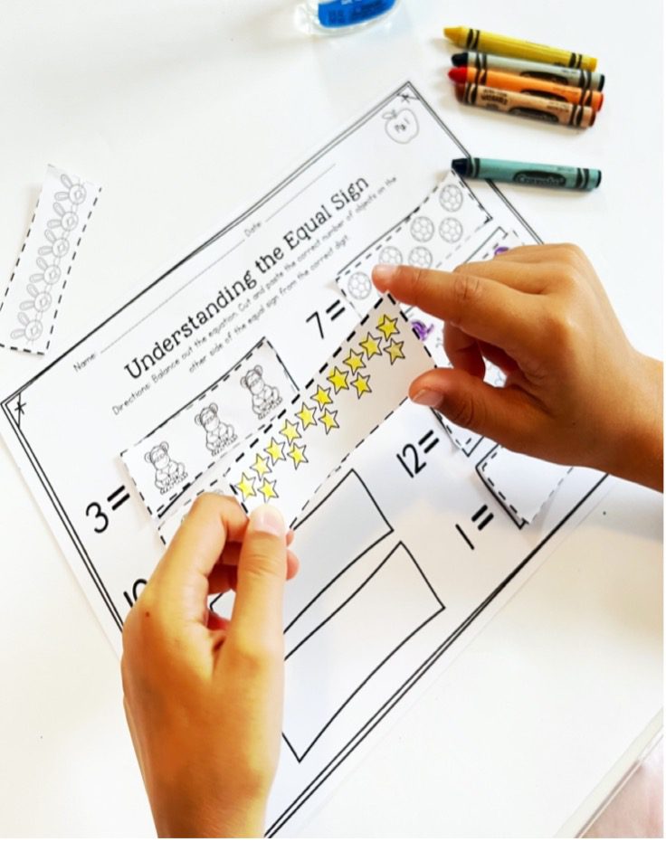 Students use cut and paste to balance simple equations to help understand the equal sign.